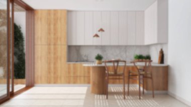 Blurred background, scandinavian kitchen. Island with stools and decors, parquet floor. Japandi interior design