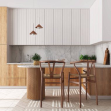 Blurred background, japandi wooden kitchen. Dining island with chairs. Herringbone parquet floor and potted plants. Contemporary interior design