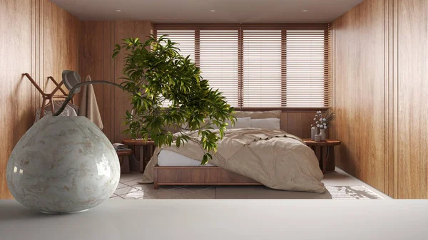 White mat table shelf with round marble vase and potted bonsai, green leaves, over minimal wooden bedroom with master bed, zen clean architecture concept idea