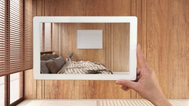 Gelişmiş gerçeklik kavramı. Mermer döşemeli, ahşap yatak odalı boş ahşap iç döşemeli mobilya ve tasarım ürünlerini simule etmek için kullanılan AR uygulamalı el bilgisayarı.