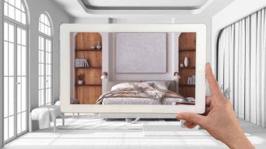 Gelişmiş gerçeklik kavramı. Özel mimari tasarımı, tamamen beyaz arka plan, ahşap yatak odası gibi mobilya ürünlerinin simülasyonunda kullanılan AR uygulaması ile el ele tutuşma tableti