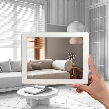 Gelişmiş gerçeklik kavramı. Özel mimari tasarımlı mobilya ürünlerini taklit etmek için kullanılan AR uygulamalı tablet, tamamen beyaz arka plan, japandi oturma odası