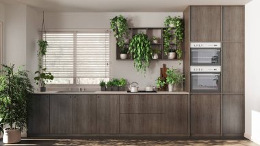 Beyaz ve bej tonlarda, dolapları ve aletleri olan modern, koyu renk ahşap bir mutfak. Venedik panjurlu pencere. Biyofilik konsept, birçok ev bitkisi. Kentsel orman iç tasarımı