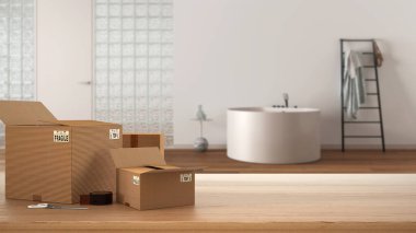 Ahşap masa, masa ya da rafta yığınla karton kutu, cam tuğlalı banyo manzarası, iç tasarım, fotokopi alanı olan taşınan ev konsepti.