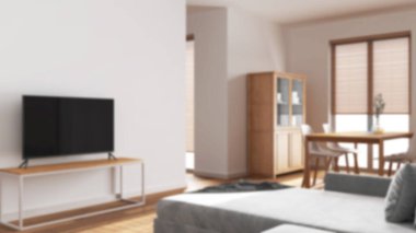 Arka plan bulanık, japandi oturma ve yemek odası. Kadife kanepe, beyazlatılmış ahşap masa, sandalyeler, dolaplar ve bölme duvarı. En düşük iç tasarım