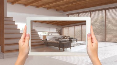 Gelişmiş gerçeklik kavramı. Boş ahşap iç mekanlarda mobilya ve tasarım ürünleri canlandırmak için kullanılan AR uygulamalı el bilgisayarı tableti, asgari mutfak ve oturma odası