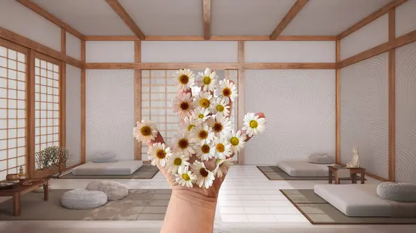 Woman\'s hand holding daisies, spring and flowers idea, over japandi meditation room, wooden roof ceiling, tatami, resin floor, interior design idea
