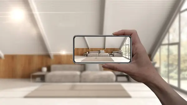 Augmented reality concept. Hand holding smart phone with AR application used to simulate furniture and interior design products in real home, mezzanine living room