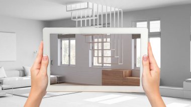 Gelişmiş gerçeklik kavramı. El ele tutuşma tableti, mobilya ve tasarım ürünlerini bembeyaz arka planda canlandırmak için kullanılan AR uygulaması. Koltuklu en az oturma odası.