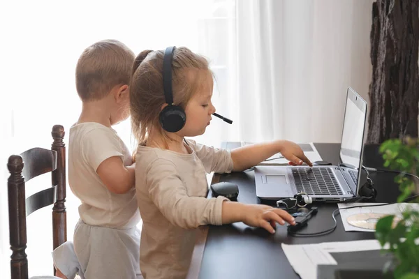 Little kids play with computer of parents