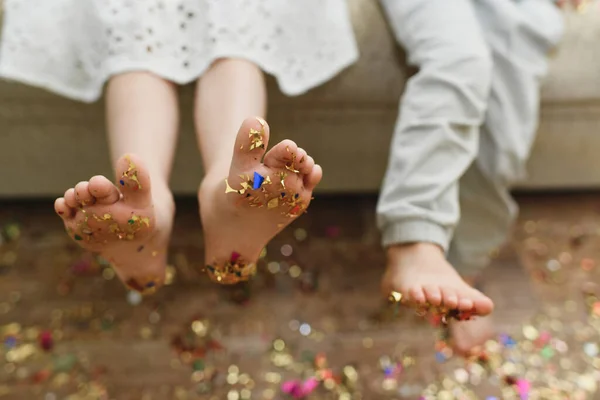 The childrens bare feet with confetti on their feet