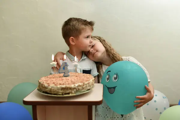 Sister congratulates brother on his birthday Cake with the candles