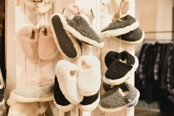 Sheep wool slippers hanging at the store