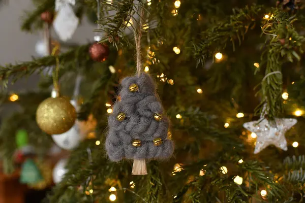 Wool fir-tree and toys hanging on the christmas tree