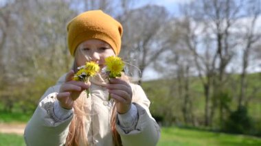 Baharda çayırda çiçek toplayan bir kız.