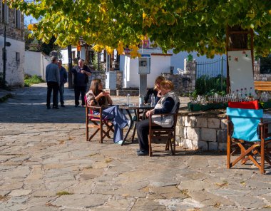 Quiet village life in the low tourist season on an island on Lake Pamvotida in Ioannina, Greece clipart