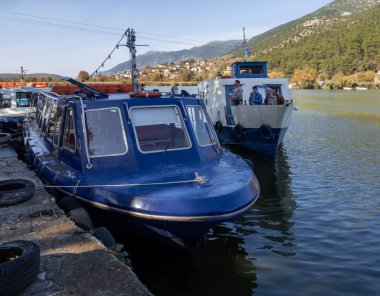 Quiet village life in the low tourist season on an island on Lake Pamvotida in Ioannina, Greece clipart