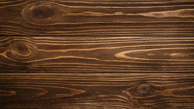 Koyu kırsal ahşap arka plan yüzeyinde eski doğal desenler var. Üst görünüm, metin veya tasarım için boşluk