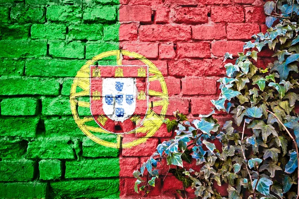 Portugal grunge flag on brick wall with ivy plant, country symbol concept