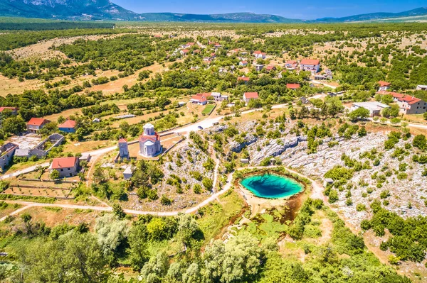 stock image Cetina river source water hole and Orthodox church aerial view, Dalmatian Zagora region of Croatia