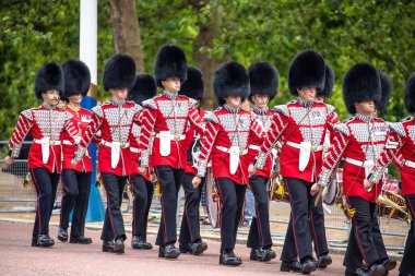 London, United Kingdom, June 26 2023: Grenadier Guards after being relieved from their sentry postings at Buckingham Palace. Kings guard walk the Mall, guards change is famous tourist attraction in London, capital of United Kingdom. clipart