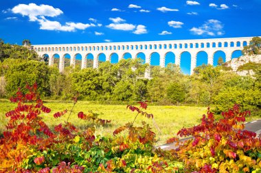 Roquefavour stone Aqueduct in green landscape scenic view, landmark of southern France clipart