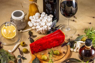 Red pesto cheese on wooden board, surrounded by fresh ingredients, wine, and balsamic vinegar, creating an inviting scene for italian cuisine lovers clipart