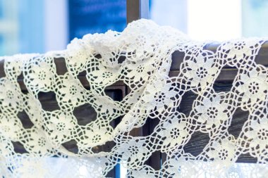 Ahşap bir çerçeveye sarılı narin beyaz örgü danteli. Sahneye biraz klasik cazibe ve zarafet katıyor.