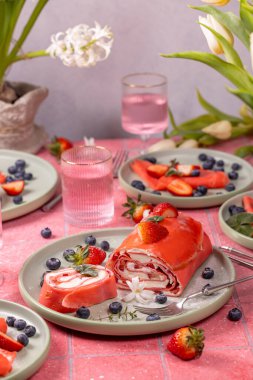 Lezzetli pembe çilekli pasta bahar kutlaması için taze çilek ve yaban mersiniyle süslenir.