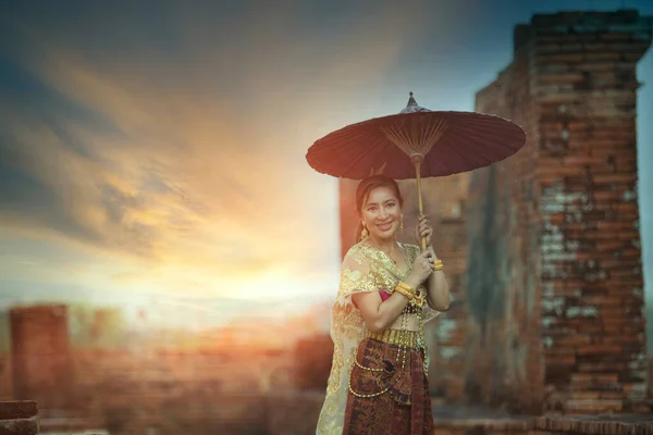 Красивая Азиатская Женщина Держит Бамбуковый Зонтик Стоя Против Старого Храма — стоковое фото