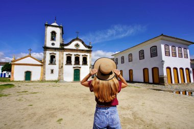 Tourism in Brazil. Young woman visiting the historic town of Paraty UNESCO World Heritage Site, Rio de Janeiro, Brazil.