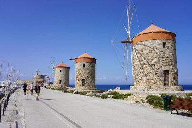 RHODES, GREECE - MAY 10, 2022: Mandraki Marina and port with Rhodes Windmills, Greece