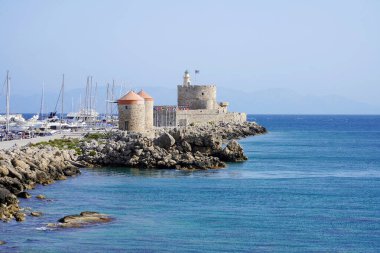 Mandraki Marina and port with Rhodes Windmills and Fort of Saint Nicholas, Greece