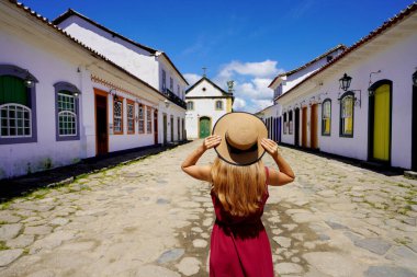 Colonial architecture in Latin America. Young tourist woman in the historic town of Paraty, Brazil, South America.