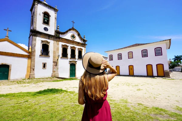 Holidays in Brazil. Young woman visiting the historic town of Paraty UNESCO World Heritage Site, Rio de Janeiro, Brazil.
