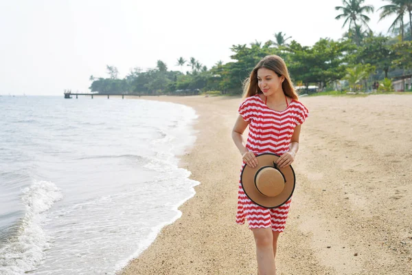 stock image Beautiful young tourist woman on empty tropical beach. Pretty girl walking on sand beach in Brazil. Escape travel concept.