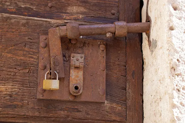Antique rusty door latch in the Italian countryside.
