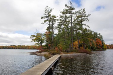 Wooden Bridge to Island on Hardy Lake in Muskoka Area, Canada. clipart