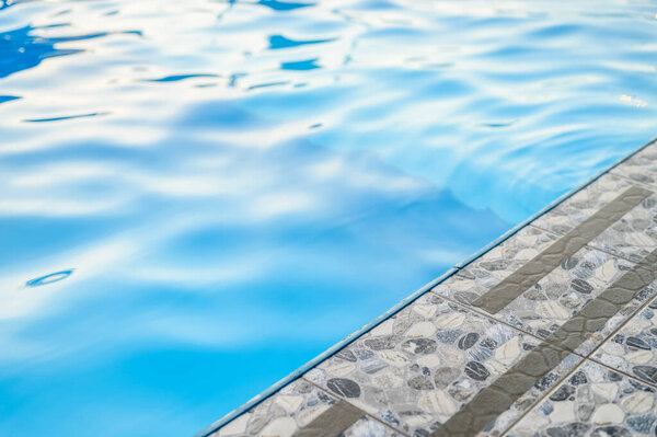 Tiles near the pool. Stone imitation. Swimming pool by the sea travel vacation in the park vacation background