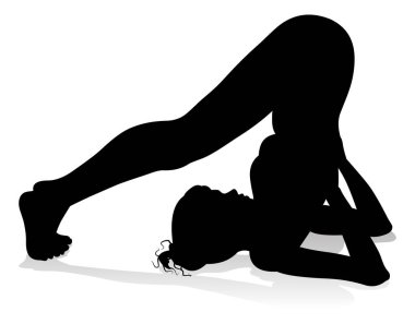 Yoga yapan ya da pilates yapan bir kadının silüeti.