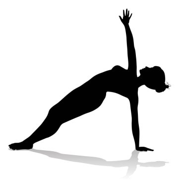 Yoga yapan ya da pilates yapan bir kadının silüeti.