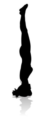 A silhouette of a woman in a yoga or pilates pose clipart