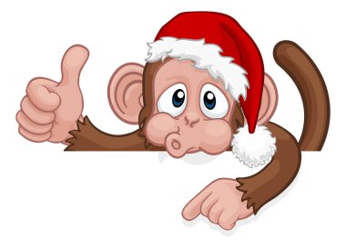 Noel Baba şapkalı bir Noel maymunu bir tabelanın arkasına bakıp işaret ederken baş parmağını kaldırıyor.