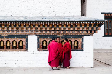 Punakha, Bhutan - 03 Şube Üyesi, 2018: 3 Budizm öğrencisi keşiş Chimi Lhakang Manastırı, Punakha, Butan 'da ibadet çarkları başında duruyor. Yüksek kalite fotoğraf