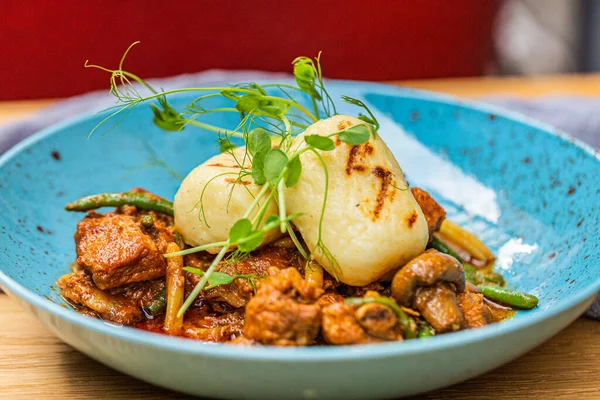 stock image Hungarian goulash with a bread dumpling prepared on the grill. Close up 