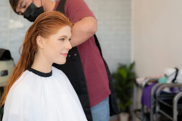 European woman hairdresser in beauty salon cut hair and hair design to her customer