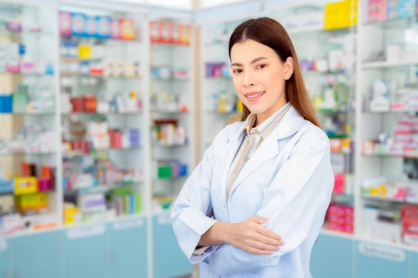 Asian pharmacist woman in pharmacy store of her business for sale a drug and pharmacy