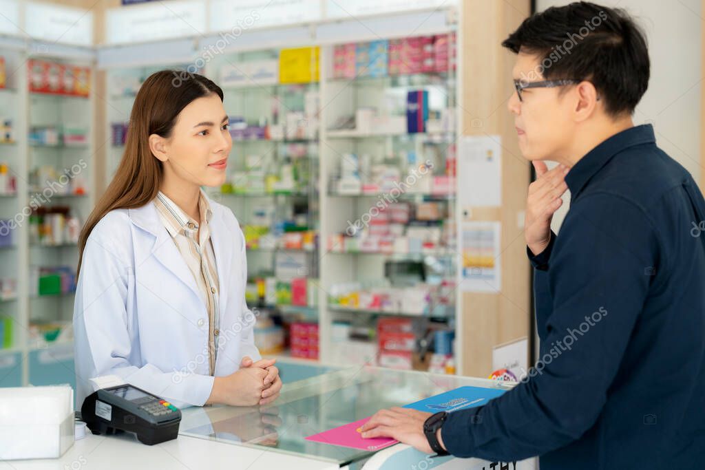 Asian pharmacist woman in pharmacy store of her business for sale a drug and pharmacy with her customer