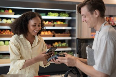 A man shopping in convenience store  on shelf in freezer in convenience store and pay money by barcode scan from mobile phone