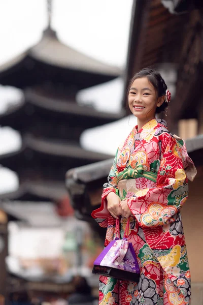 Asian traveler girl in Kimono traditional dress walking in old temple in Kyoto city, Japan
